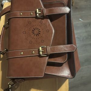 Brown Leather Satchel with Embossed Design and Buckle Straps